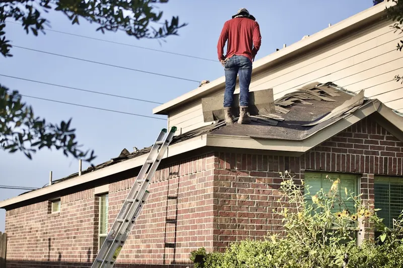 Professional roofer working on a residential roof in Woodlawn Acres